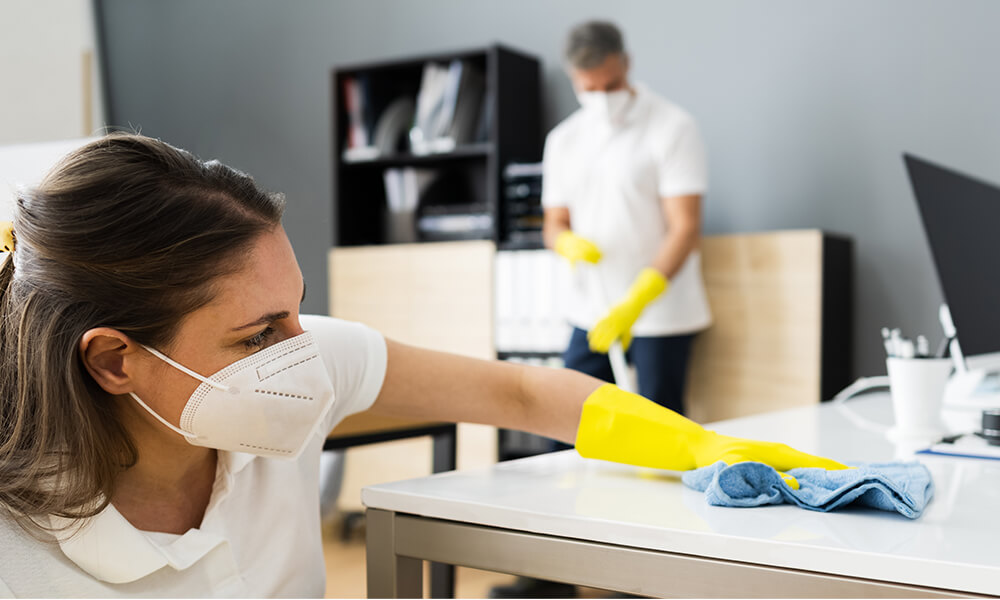 woman cleaning office desk